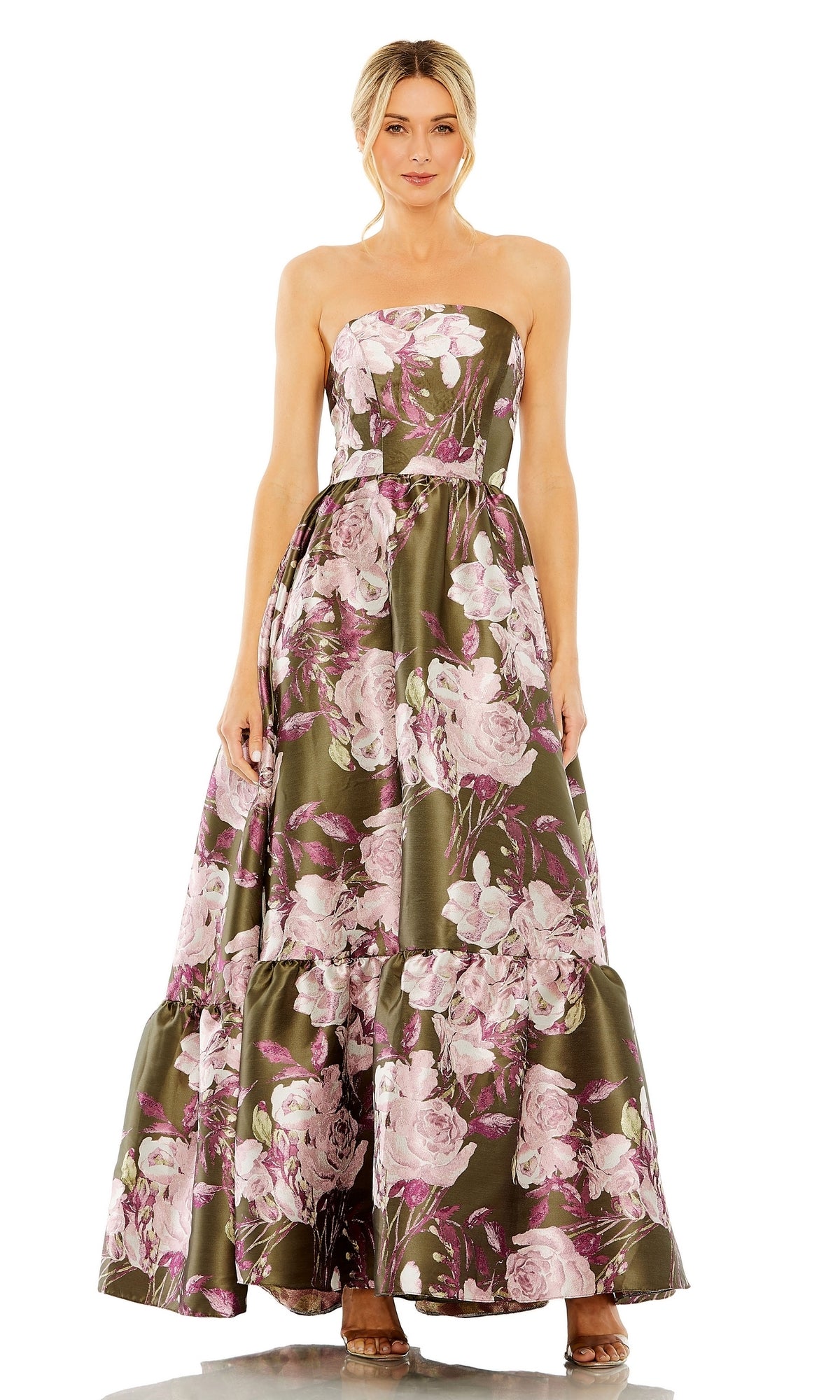 A woman stands facing forward in the Mac Duggal 11605, a green floral-print formal dress that is strapless and flows gracefully to the floor.